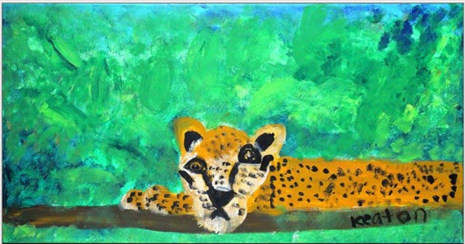 A painted jaguar among green leaves
