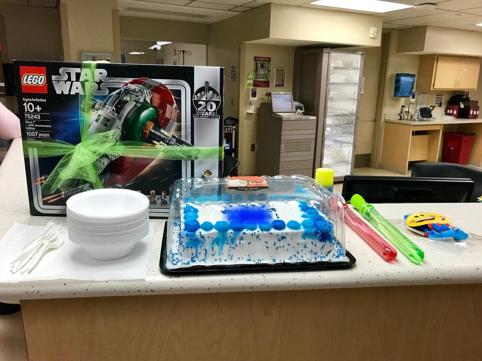 A breakout party table with a Lego set, cake and treats