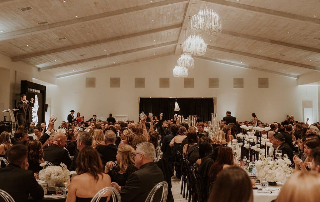 Guests seated at tables in the gala ballroom